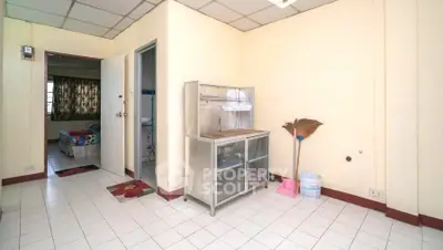 Cozy interior with tiled flooring and simple furnishings, ideal for budget-conscious living.