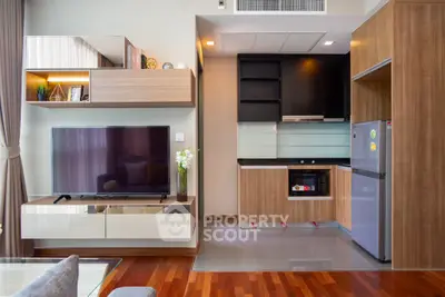 Modern living room with stylish kitchen and wooden flooring
