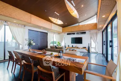 Luxurious open-plan living room with modern decor and large windows offering natural light.