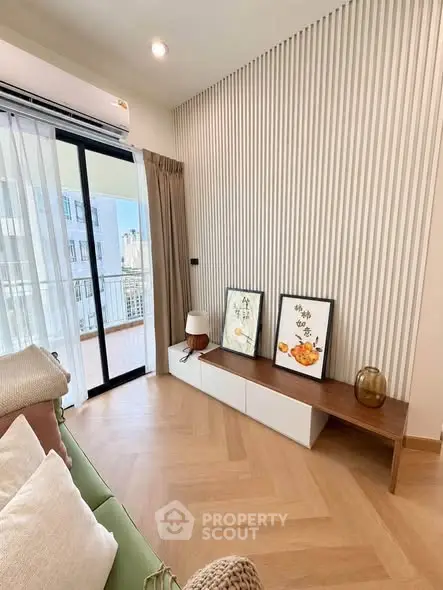 Modern living room with stylish decor and balcony view in a high-rise apartment.