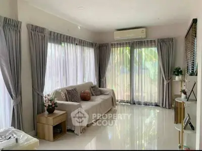 Bright and airy living room with large windows and elegant curtains