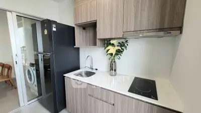 Modern kitchen with sleek cabinetry, induction cooktop, and integrated appliances in a stylish apartment.