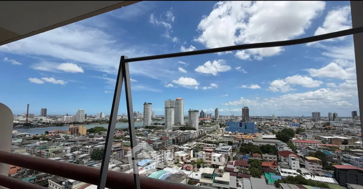 Stunning cityscape view from high-rise balcony with clear blue sky