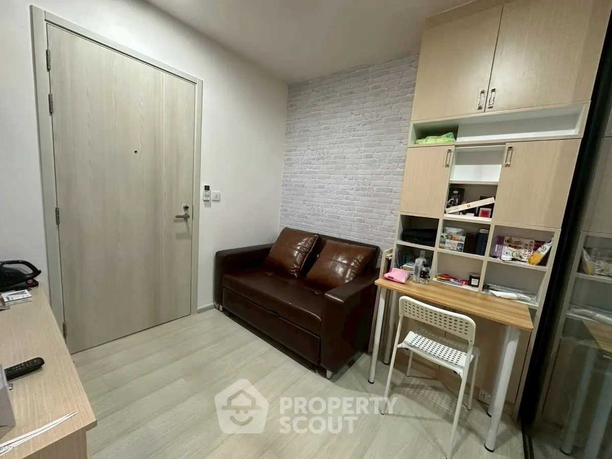 Cozy small living room with leather sofa and modern storage solutions