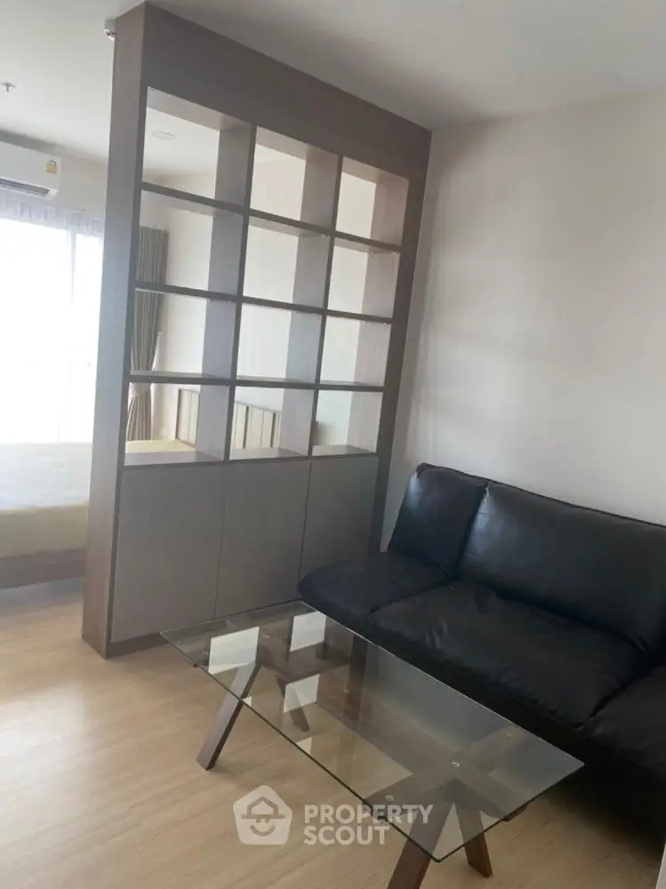 Modern living room with glass coffee table and stylish shelving unit
