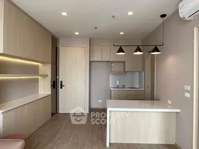 Modern kitchen with sleek cabinetry and open layout in stylish apartment