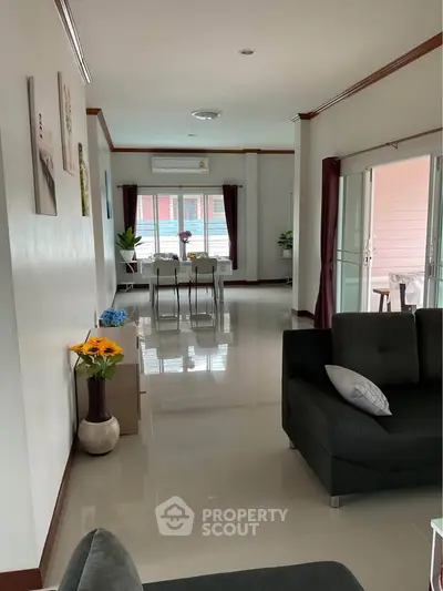Spacious modern living room with sleek design and abundant natural light, perfect for family gatherings.