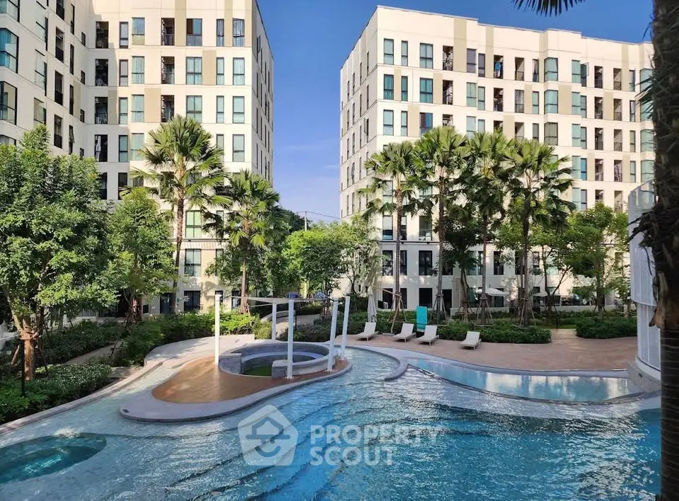 Luxurious apartment complex with stunning pool and lush greenery