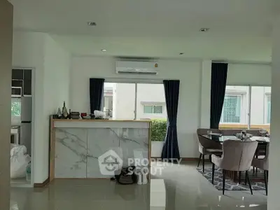 Modern open-plan living and dining area with stylish decor and natural light.