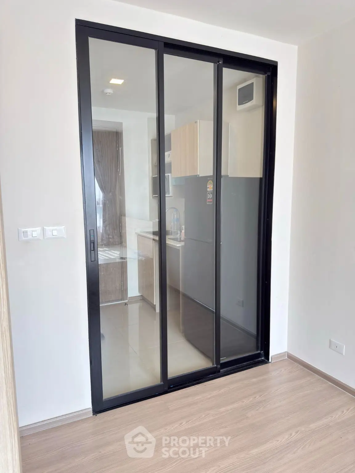Modern kitchen with sliding glass door and sleek cabinetry