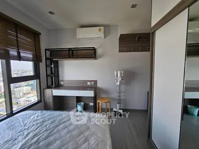 Modern bedroom with city view, featuring sleek furniture and air conditioning, perfect for urban living.