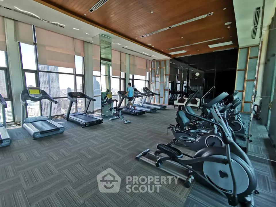 Spacious modern gym with city view and state-of-the-art equipment
