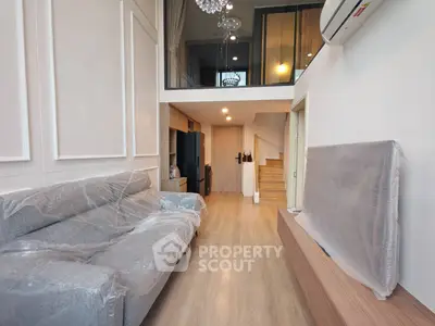 Modern duplex living room with stylish decor and mezzanine level