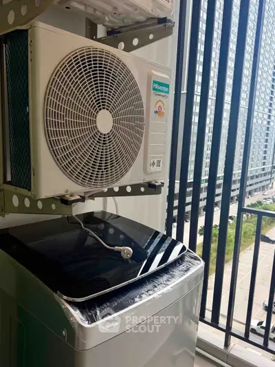 Modern apartment balcony with air conditioning unit and city view, perfect for urban living.