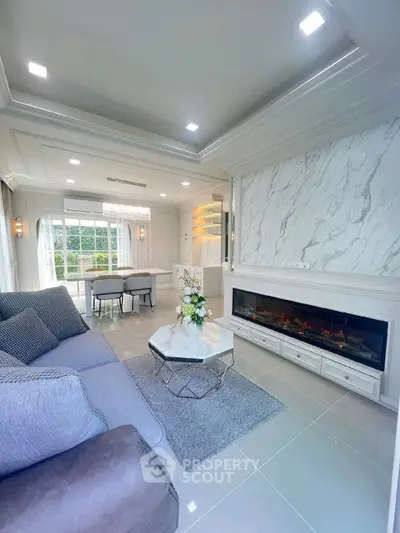 Luxurious living room with elegant marble accents and modern fireplace, perfect for sophisticated living.