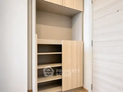 Modern built-in storage cabinet with wooden finish in a contemporary home interior.