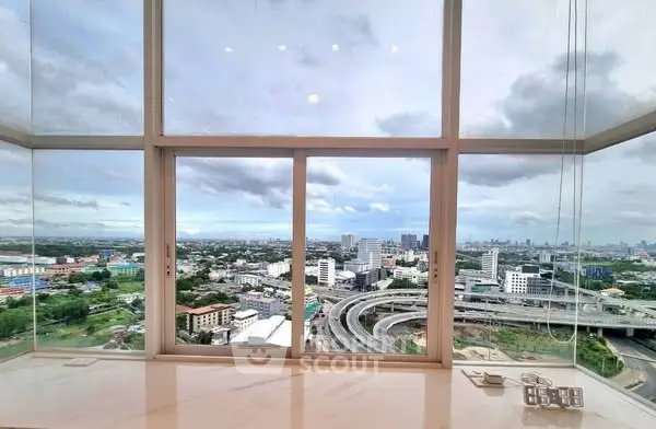 Stunning cityscape view from a high-rise window with expansive skyline and urban landscape.