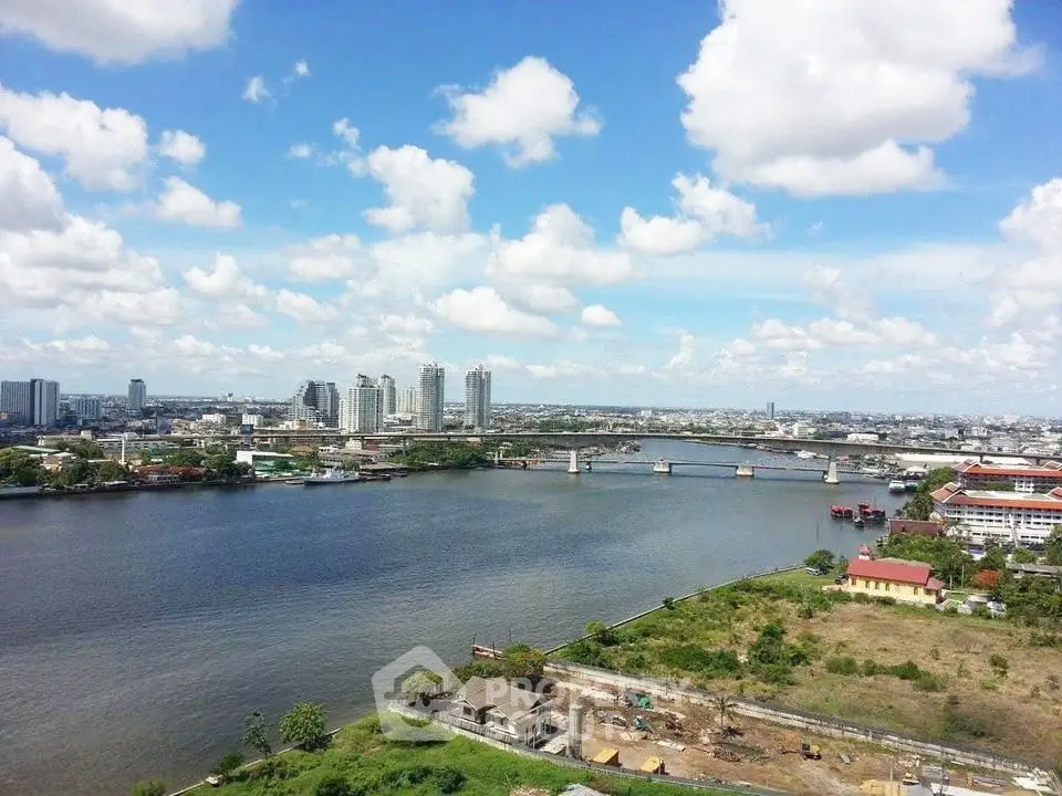Stunning river view with city skyline and blue sky, perfect for urban living.