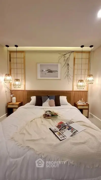 Cozy bedroom with elegant lighting and modern decor, perfect for relaxation.
