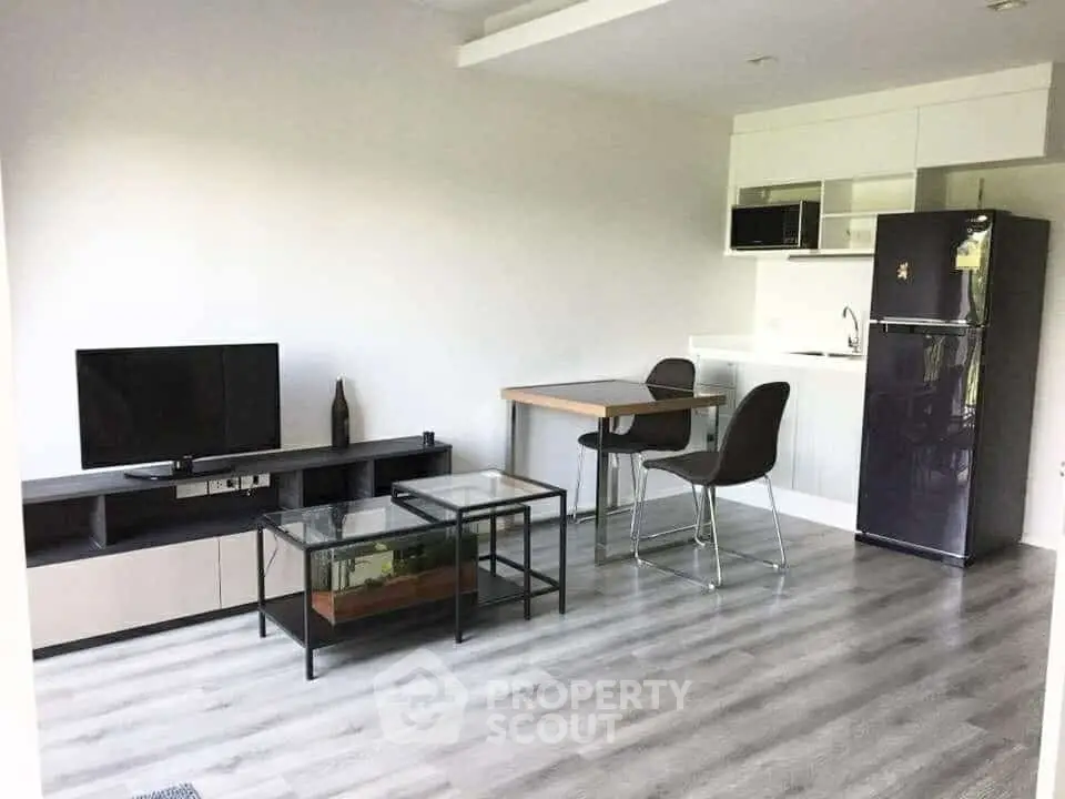 Modern open-plan living room with sleek kitchen and stylish furniture