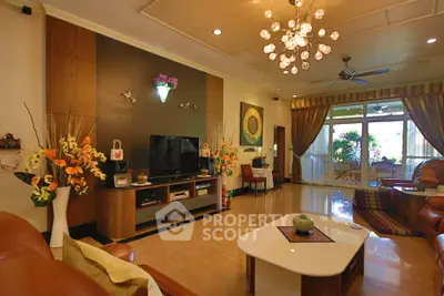 Luxurious living room with elegant decor and large windows offering natural light.