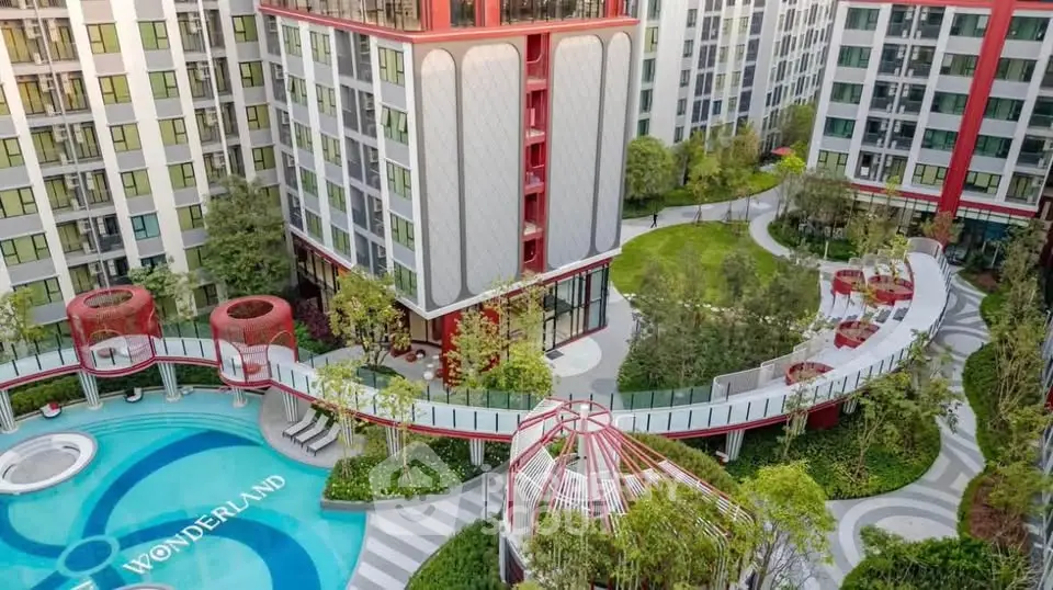 Luxurious residential complex with modern architecture and lush gardens, featuring a unique pool design.