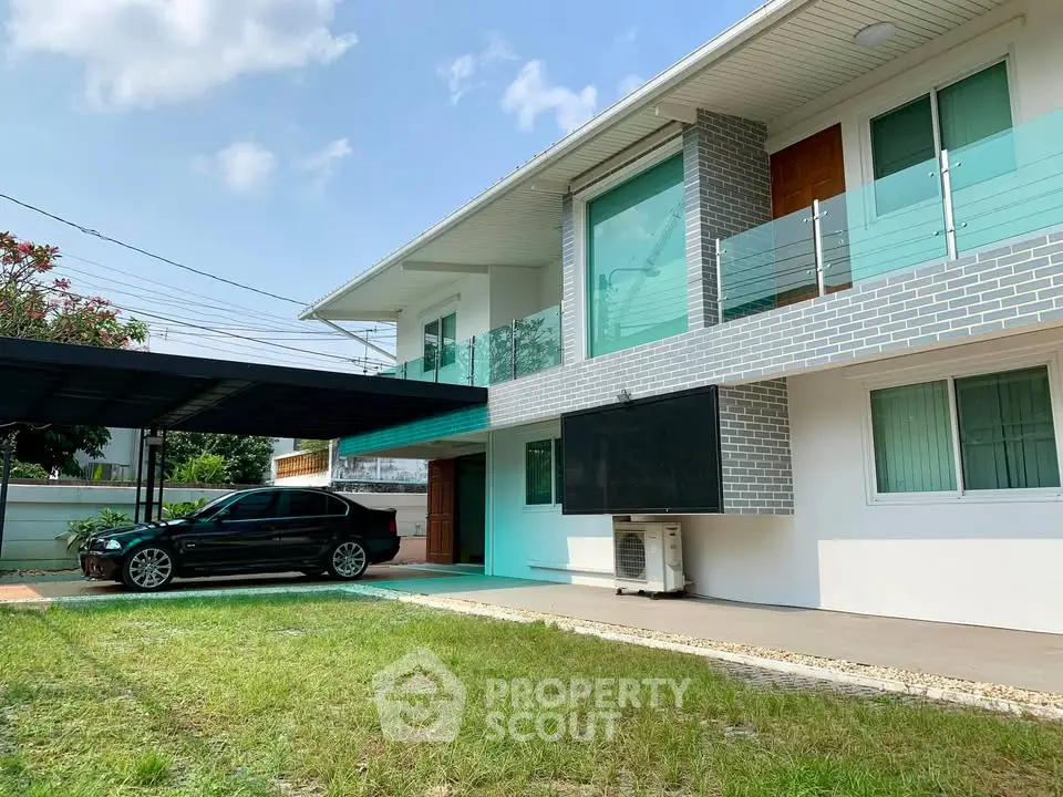 Modern two-story house with carport and spacious front yard