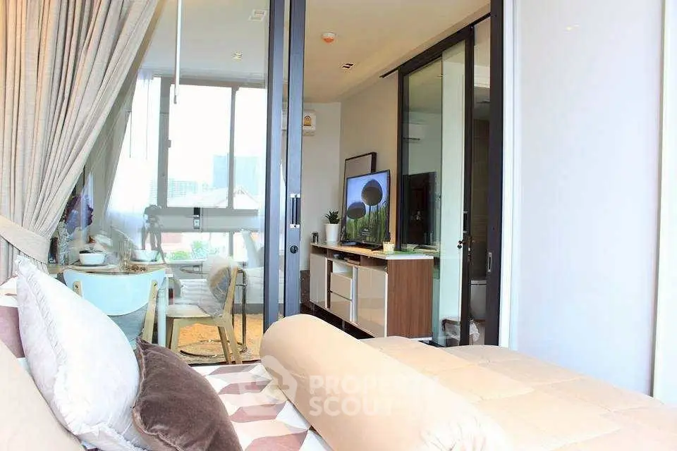 Modern living room with stylish decor and large windows offering natural light.