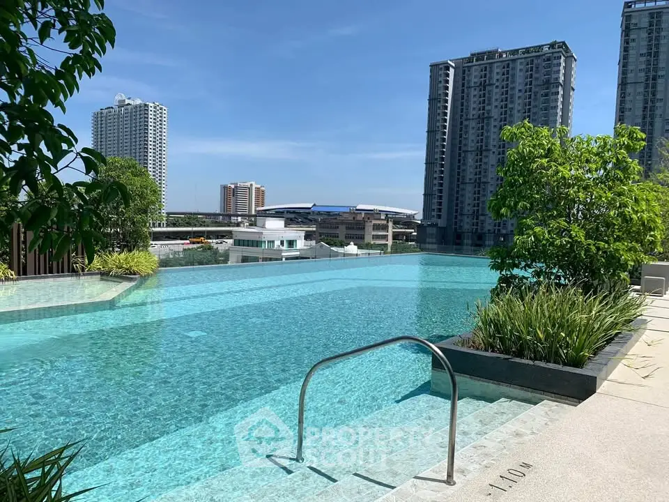 Luxurious rooftop pool with stunning city views and lush greenery, perfect for relaxation and leisure.
