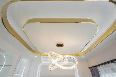 Luxurious modern ceiling design with elegant chandelier in a stylish interior space.