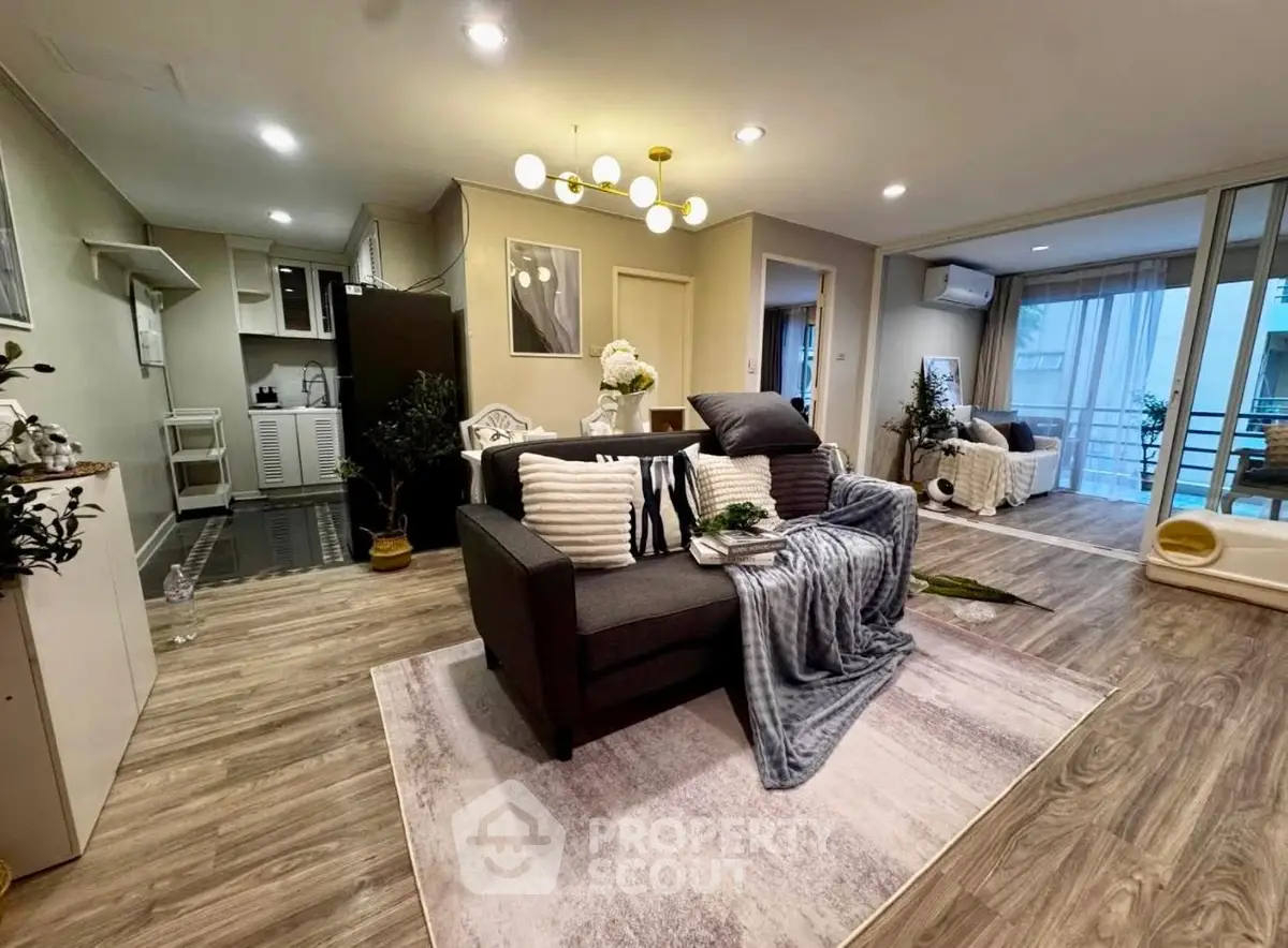Spacious modern living room with stylish decor and open layout, featuring cozy seating and elegant lighting.