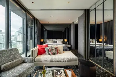 Luxurious bedroom with city view and modern decor, featuring floor-to-ceiling windows and stylish furnishings.