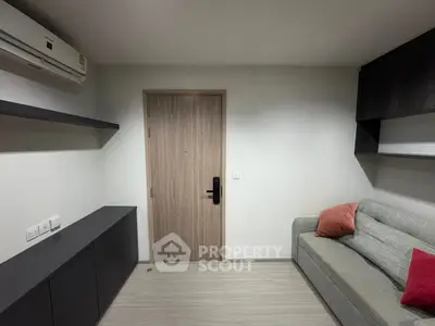 Modern living room with sleek design, featuring a cozy sofa and minimalist decor.