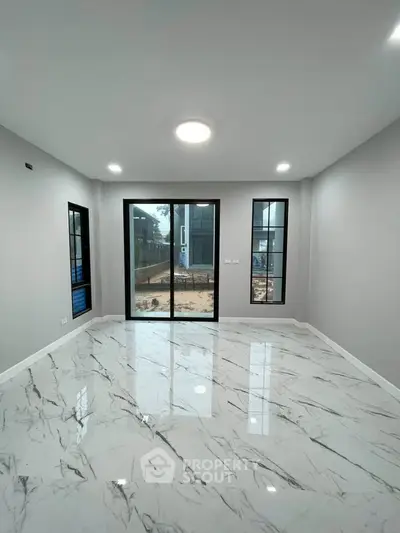 Spacious modern living room with marble flooring and large windows