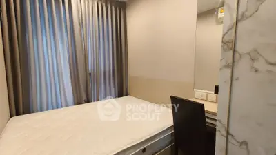 Cozy bedroom with elegant curtains and a comfortable bed, perfect for restful nights.