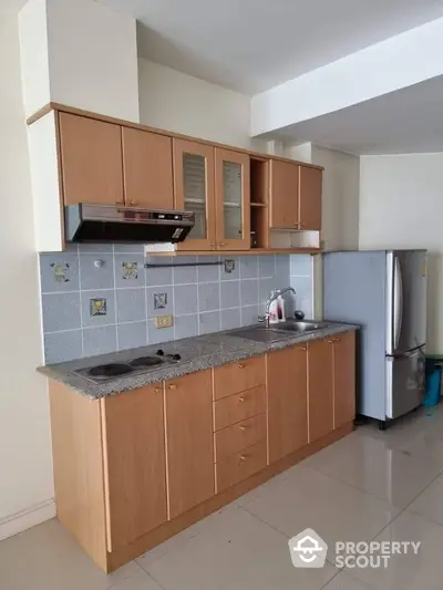 Modern kitchen with wooden cabinets and sleek appliances in a stylish apartment