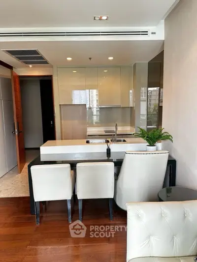 Modern kitchen with sleek design and dining area in luxury apartment