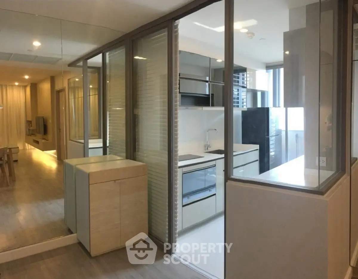 Modern open-layout apartment with sleek kitchen and spacious living area.