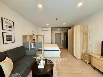 Modern studio apartment with open layout, featuring cozy living area and stylish decor.