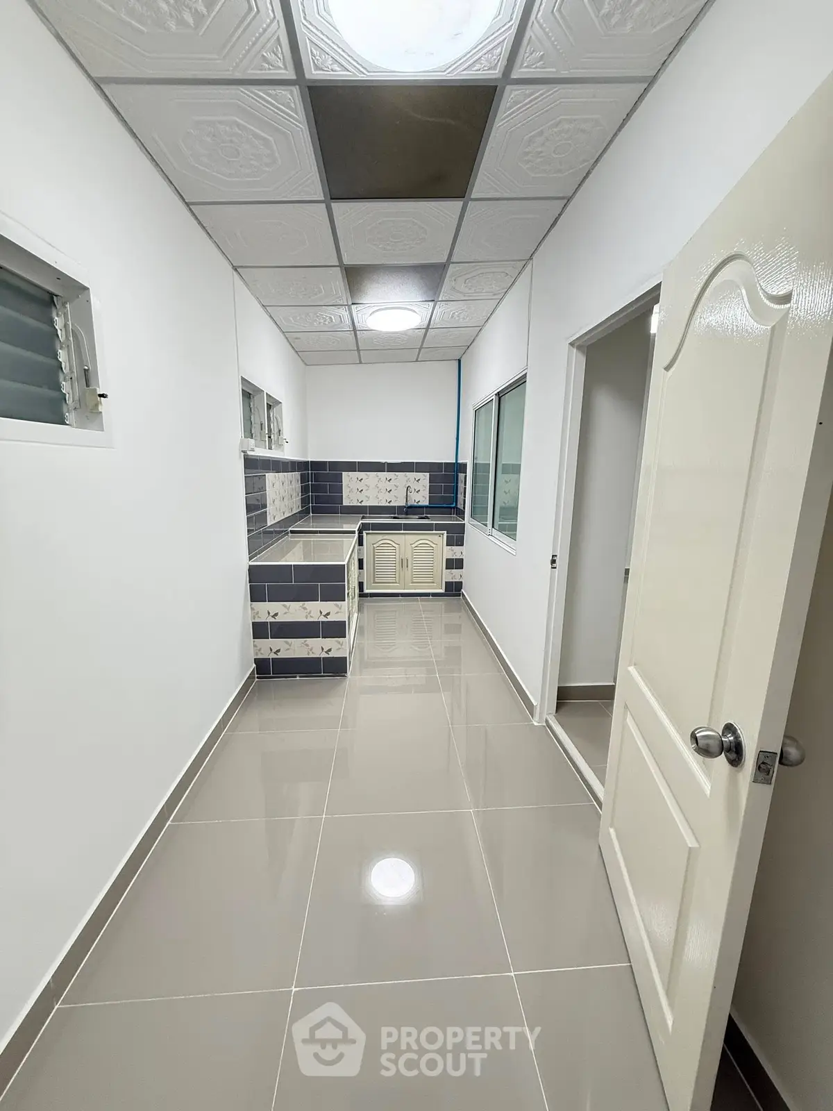 Sleek modern kitchen with closed layout and stylish tile backsplash