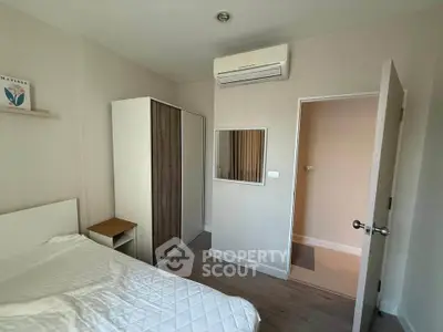 Cozy bedroom with modern wardrobe and air conditioning in a stylish apartment.