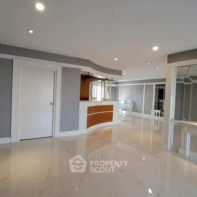 Luxurious modern living room with elegant marble flooring and stylish bar area.