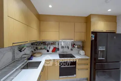 Modern kitchen with sleek wooden cabinets and high-end appliances