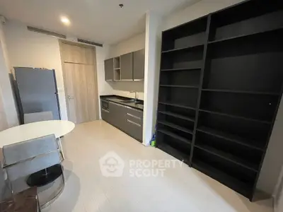 Modern kitchen with sleek cabinets and dining area in a stylish apartment.