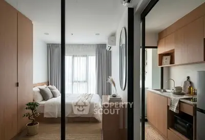 Modern studio apartment with cozy bedroom and compact kitchen