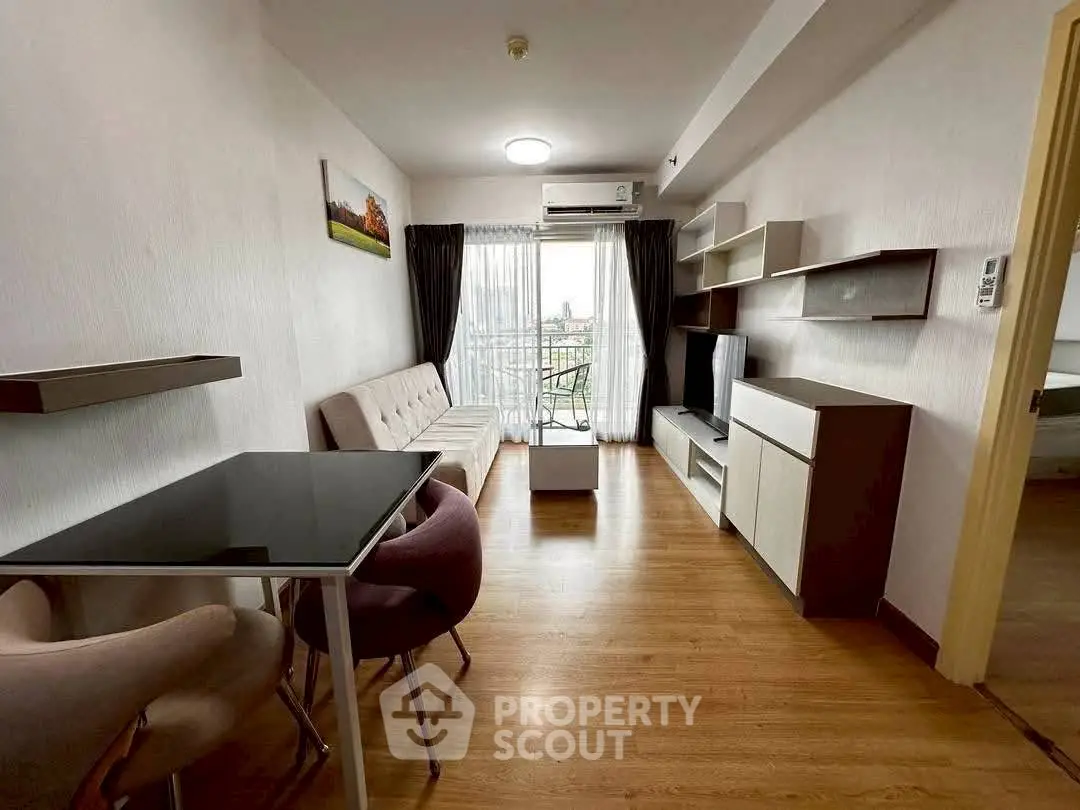 Modern living room with stylish furniture and balcony view in a cozy apartment.