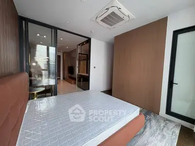 Modern bedroom with stylish design and large windows in a luxury apartment.