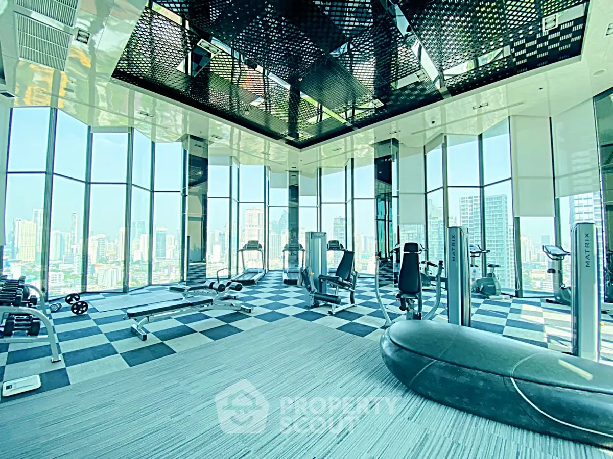 Luxurious high-rise gym with panoramic city views and modern fitness equipment.
