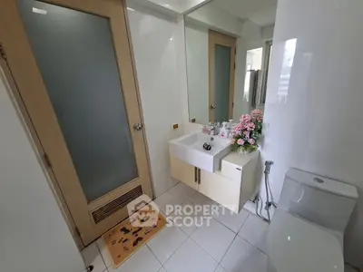 Modern bathroom with sleek fixtures and floral decor