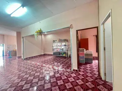 Spacious interior with unique patterned flooring and open layout, ideal for creative living space.